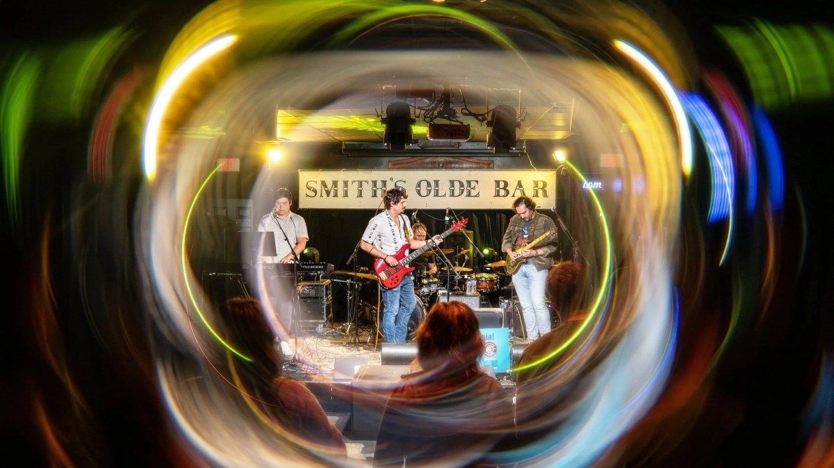 DSC04723-Enhanced-NR Band performing on stage at Smith's Olde Bar with a colorful swirling light effect.